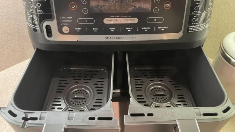 Dual-zone air fryer baskets with nonstick crisper plates inside the Ninja Foodi DZ550