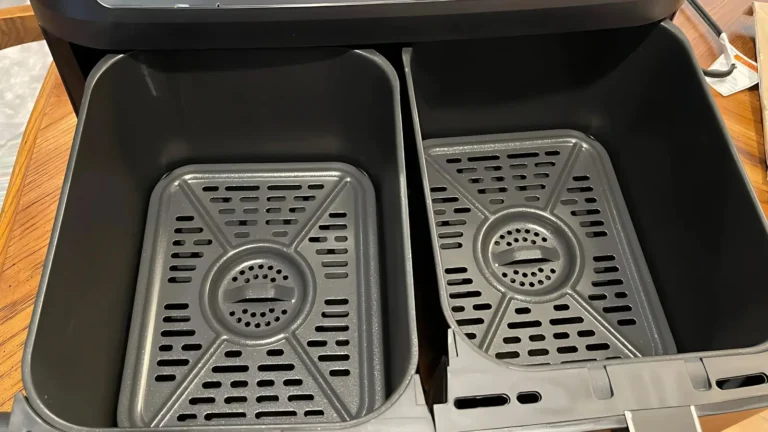 Interior view of the Ninja Foodi DZ550 air fryer showing two empty cooking drawers